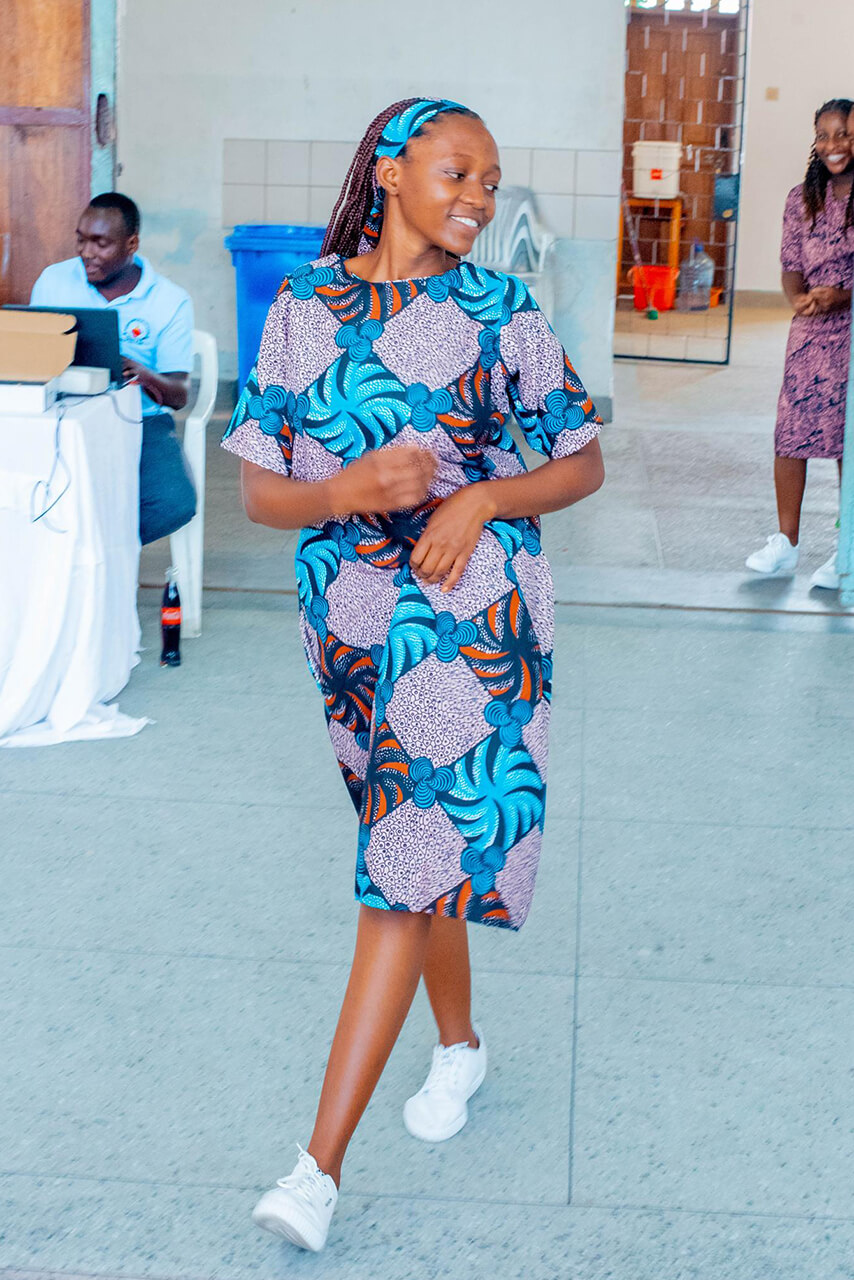 A Tansanian girl presenting her self-sewn dress